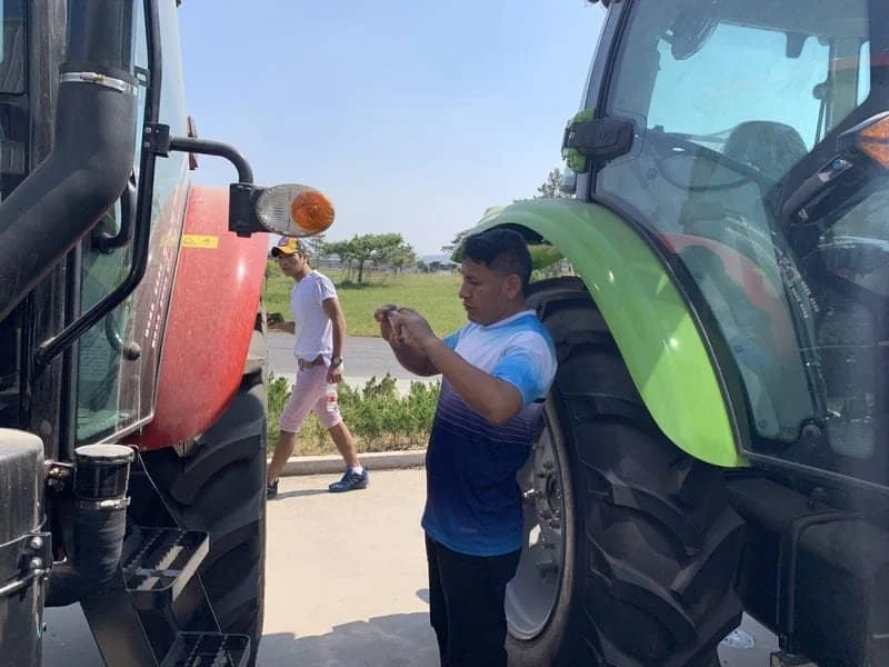 Clientes observando tractores Cropilots en el sitio, evaluando características y diseño del producto